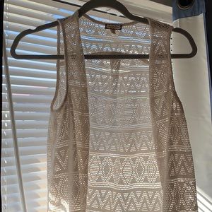 All white vest with fringes at bottom. Size S.